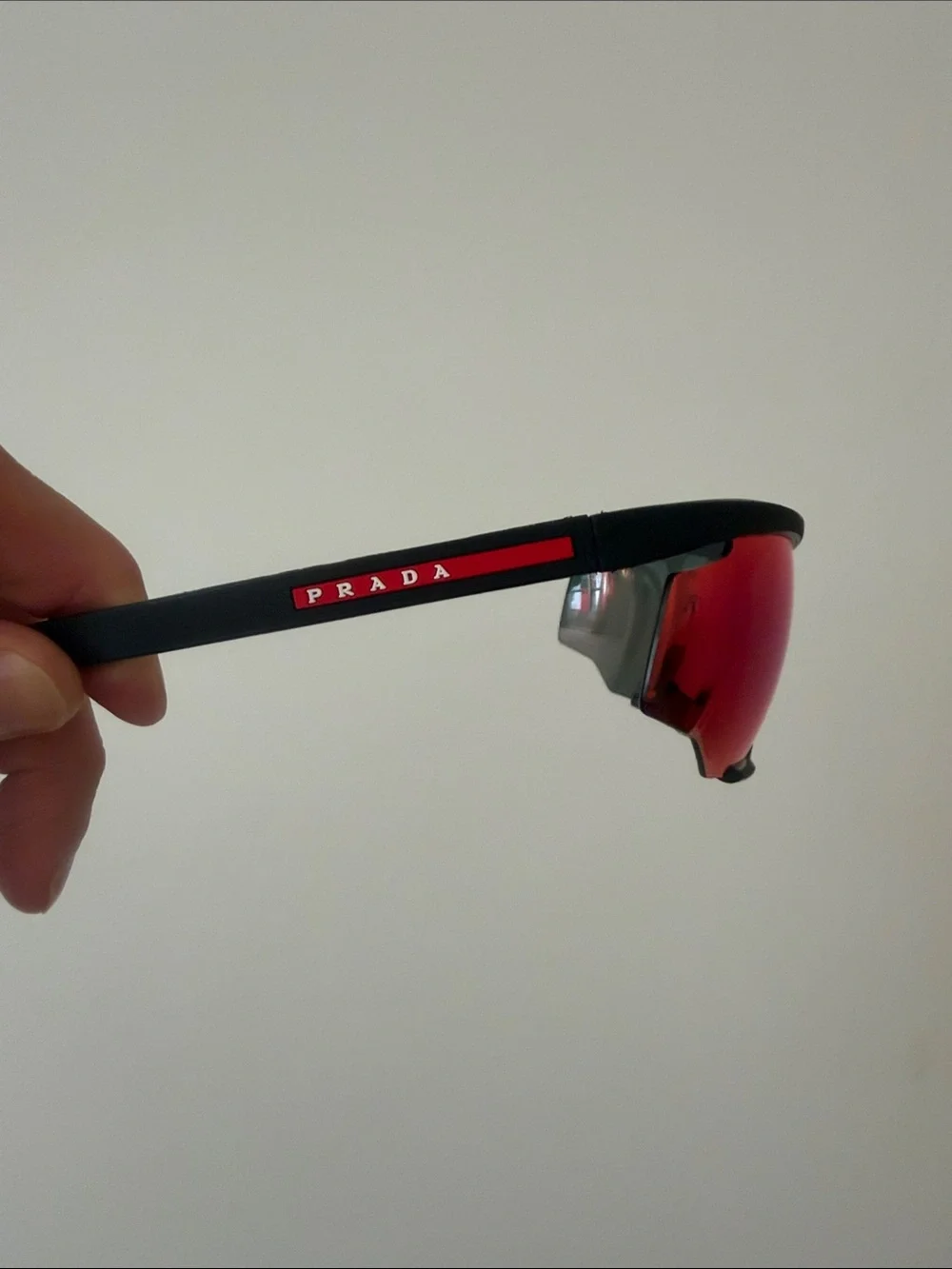Prada Sports Sunglasses with Red Mirrored Lenses